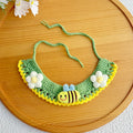 Close-up of artisan honeybee knit pet collar in green
