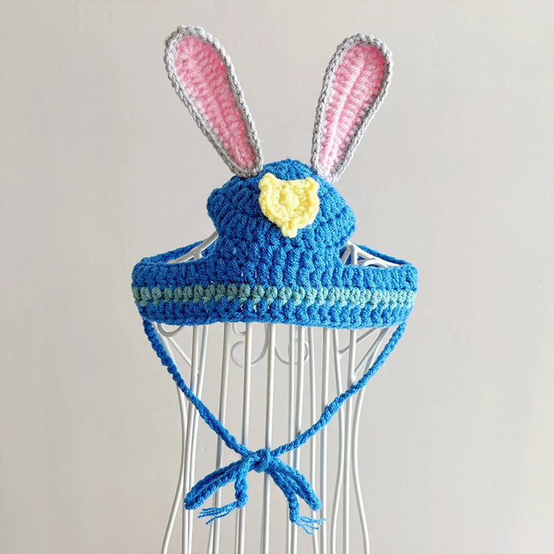 Close-up of blue knit bunny pet hat with adjustable tie strings